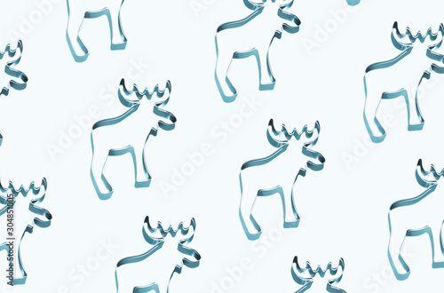 Pattern made of silver reindeers on blue background. Christmas and New Year concept. © Olga Zarytska