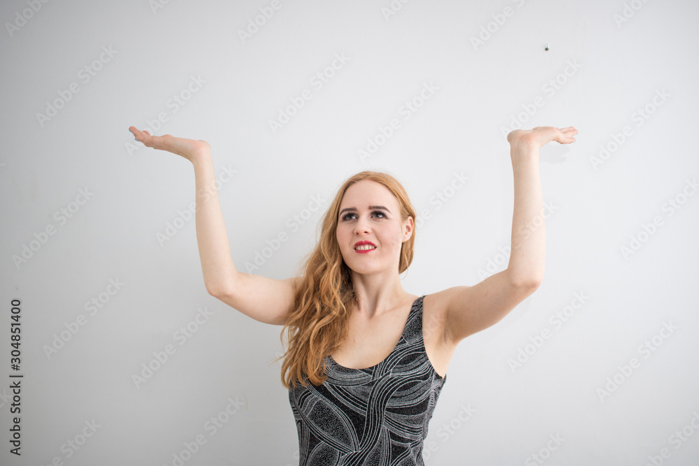 Beautiful long red health hair young attractive woman isolated white background gray dress posing mockup advertisement finger point direction Beautiful long red health hair young attractive woman isolated white background gray dress posing mockup advertisement finger point direction