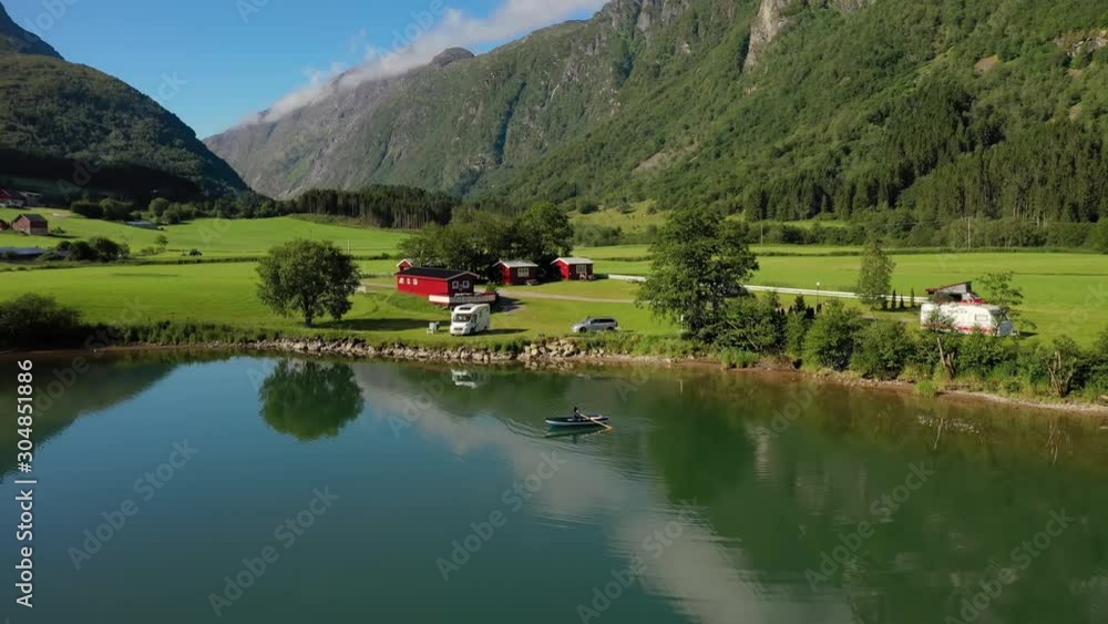 Woman on the boat catches a fish on spinning in Norway. Woman on the boat catches a fish on spinning in Norway.