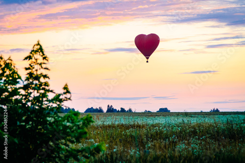 Heart shaped balloon soars in the sky