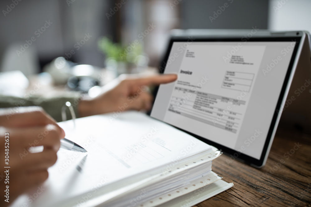 Businessman's Hands Working On Invoice On Laptop Businessman's Hands Working On Invoice On Laptop