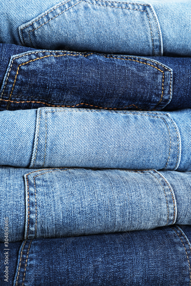Stack of different jeans as background, closeup Stack of different jeans as background, closeup