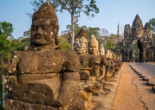 Travel concept. Row of sculptures in the South Gate of Angkor Thom complex. Location: Siem Reap, Cambodia. Beauty world.