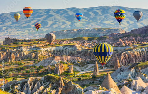 Travel concept. The great tourist attraction of Cappadocia - balloon flight. Cappadocia is known around the world as one of the best places to fly with hot air balloons. Goreme, Cappadocia, Turkey. B