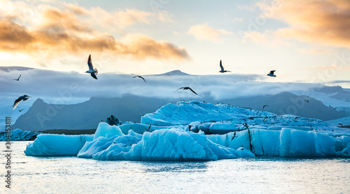 Travel concept. Beautiful sunset over the famous glacier lagoon  Jokulsarlon, view of icebergs floating. Location: Jokulsarlon glacier lagoon, Iceland. Artistic picture. Beauty world. photo