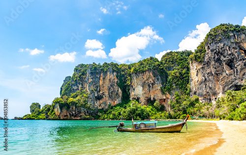 Travel concept. Amazing view of beautiful Ao Nang Beach with longtale boat. Location:  Krabi Province, Thailand, Andaman Sea. Artistic picture. Beauty world. photo