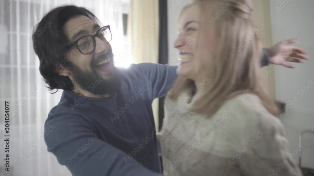 Portrait of happy Caucasian family looking at affirmative pregnancy test, hugging and kissing. Joyful future parents enjoying good news. Planned pregnancy, good relationship. Portrait of happy Caucasian family looking at affirmative pregnancy test, hugging and kissing. Joyful future parents enjoying good news. Planned pregnancy, good relationship.