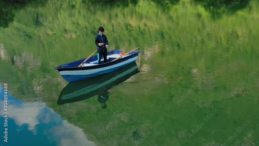 Woman on the boat catches a fish on spinning in Norway. Woman on the boat catches a fish on spinning in Norway.