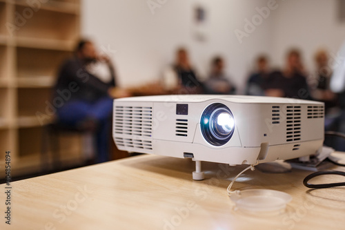 LCD video projector at business conference or lecture in a conference room or office with blurred people background photo