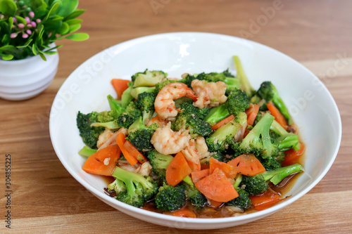 Stir Fried Broccoli with Shrimp on wooden table.