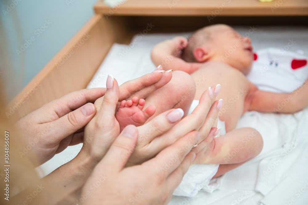 mother holding her babys feet mother holding her babys feet