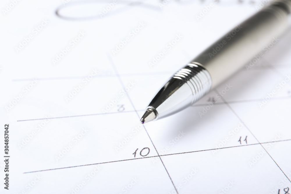 Pen on calendar page, closeup. Planning concept Pen on calendar page, closeup. Planning concept