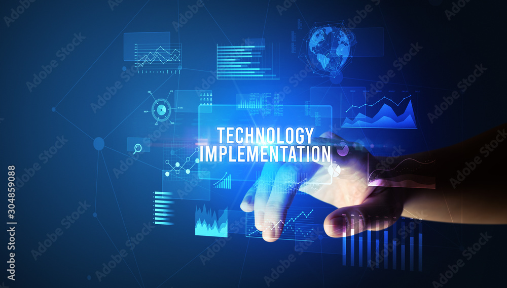 Hand touching TECHNOLOGY IMPLEMENTATION inscription, new business technology concept Hand touching TECHNOLOGY IMPLEMENTATION inscription, new business technology concept