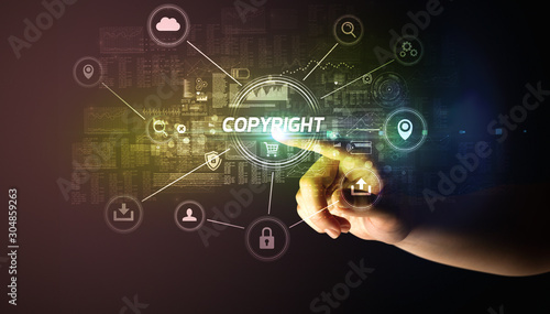 Hand touching COPYRIGHT inscription, Cybersecurity concept