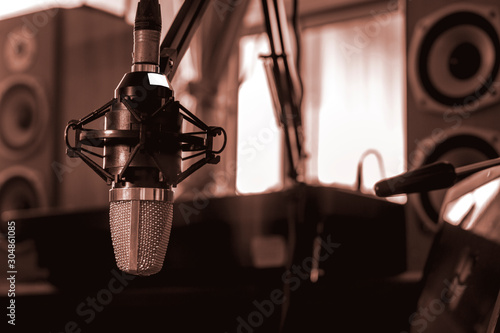 Condenser microphone and equipment for recording music, lectures, storytelling, sound The concept of creating multimedia in teaching and learning. A recording room at home.