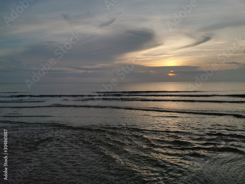 Fototapeta Naklejka Na Ścianę i Meble -  Beautiful dawn, morning sun rises by the sea. Scenic beach, sea, ocean, coastline, rocks, sands, cloudscape and skyline photography.