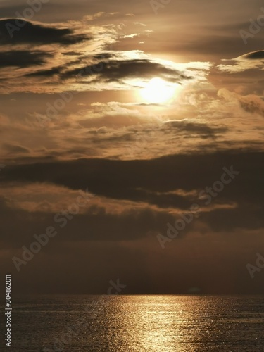 Beautiful dawn, morning sun rises by the sea. Scenic beach, sea, ocean, coastline, rocks, sands, cloudscape and skyline photography.