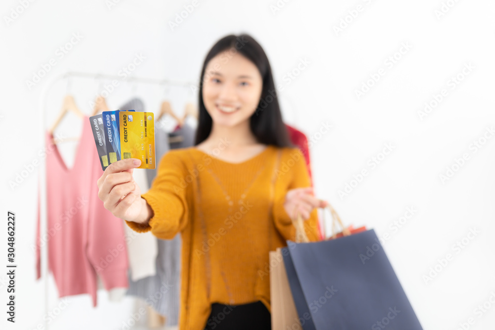 close up card, attractive asian female shopping in fashion store, she show credit card in her hand, happiness lifestyle, she feeling happy and smile close up card, attractive asian female shopping in fashion store, she show credit card in her hand, happiness lifestyle, she feeling happy and smile