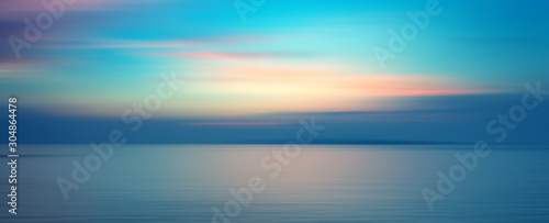 Motion blurred background of sunset on the sea