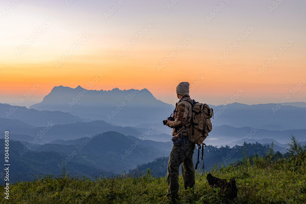 Nature photographer take photos with mirror camera on peak of mountain at morning sunrise Nature photographer take photos with mirror camera on peak of mountain at morning sunrise