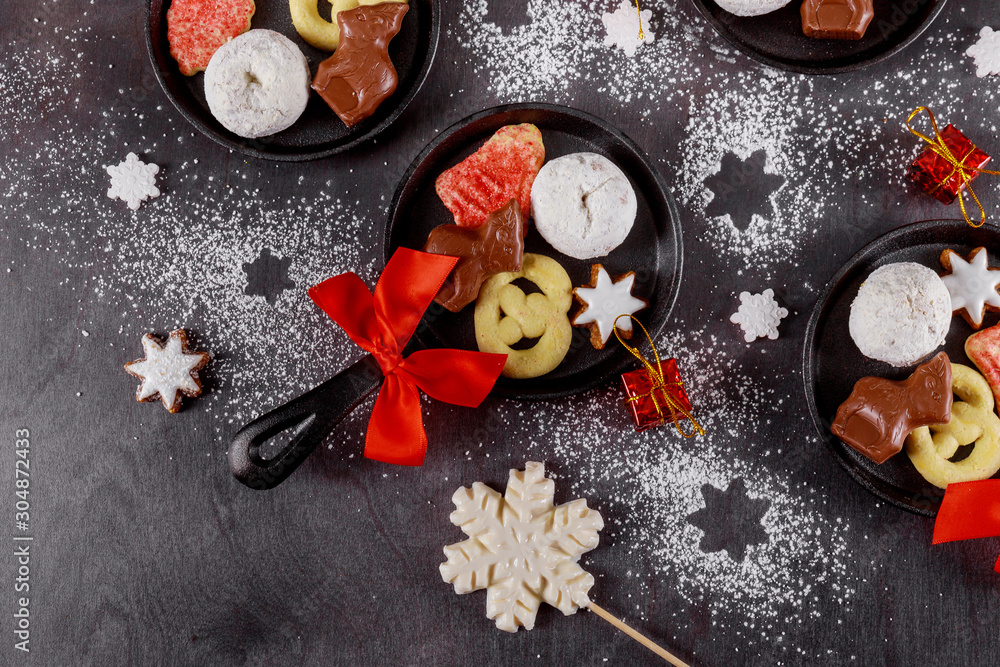 Pan with tasty Christmas cookies and chocolate on dark background. Pan with tasty Christmas cookies and chocolate on dark background.