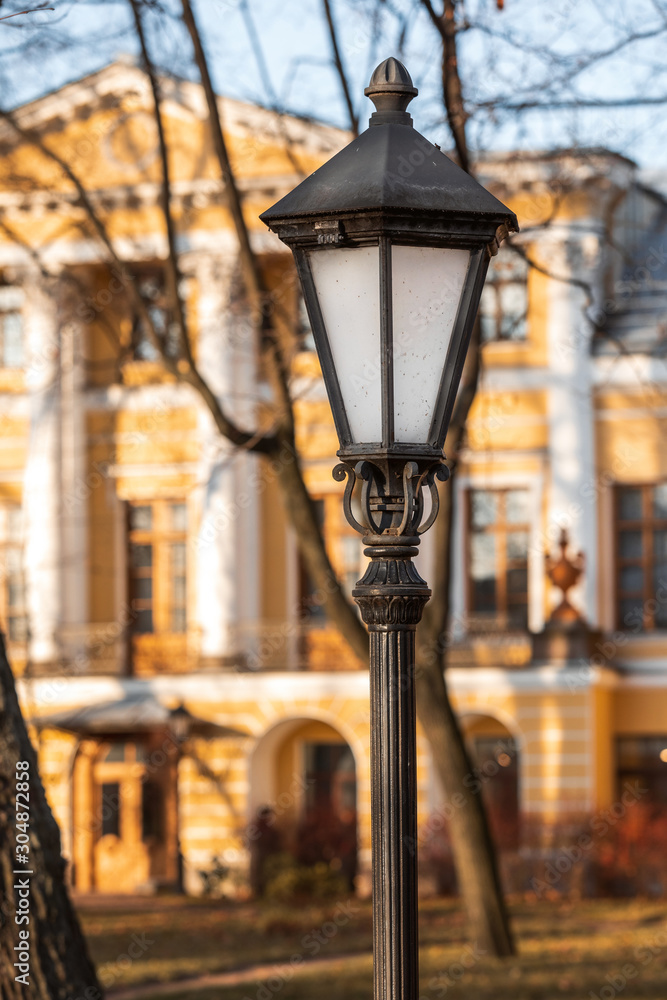 street lamp on a pillar. beautiful bright lamp on a background of the autumn city.