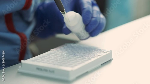 Laboratory Assistant Dripping Sample For Analysis. photo