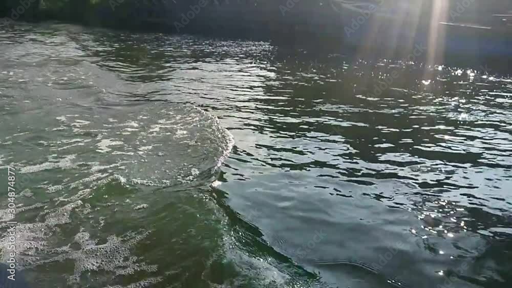 Back view from side of moving boat wave and trace. 120fps Back view from side of moving boat wave and trace. 120fps