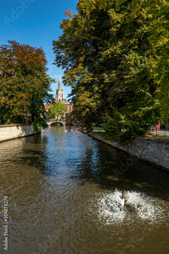 Water canal. Street view of beautiful historic city center architecture of Bruges or Brugge, West Flanders province, Belgium. Lovely summer August weather © lightcaptured