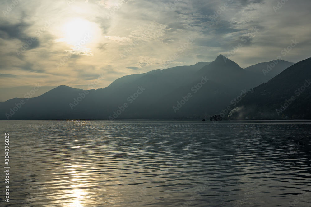 Scenic view of the Lake Maggiore at sunset on ferry boat cruising from Cannobio to Cannero Riviera, Piedmont, Italy Scenic view of the Lake Maggiore at sunset on ferry boat cruising from Cannobio to Cannero Riviera, Piedmont, Italy