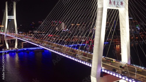 Aerial drone 4k video scene of traffic on Nanpu Spiral road at night, Nanpu bridge, Huangpu River,  Shanghai, China
