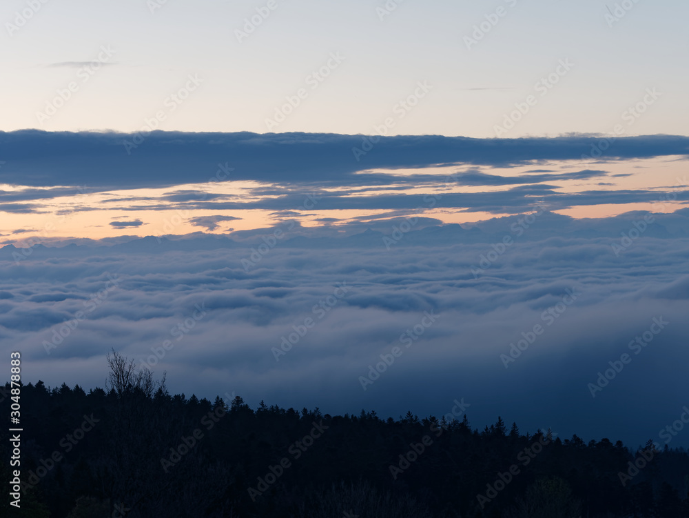 Beautiful sunrise seen from the top of the mountain above clouds