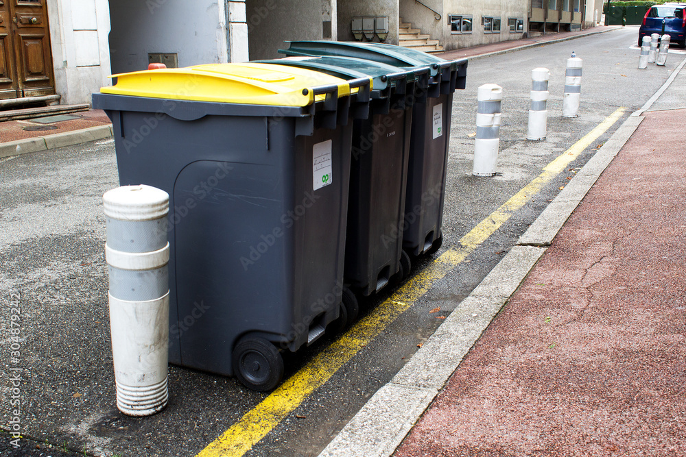 line of garbage can containers in city street line of garbage can containers in city street