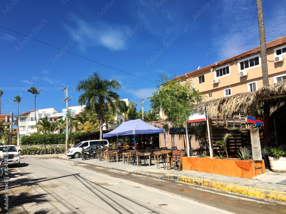 Tropical street road with houses and bars