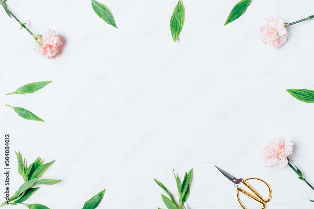Fototapeta premium Flat lay frame of pink flowers