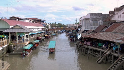 Samut Songkhram, Thailand - July 19, 2019: Amphawa canal  and village during evening sunset.  Famous traditional floating market and cultural tourist destination