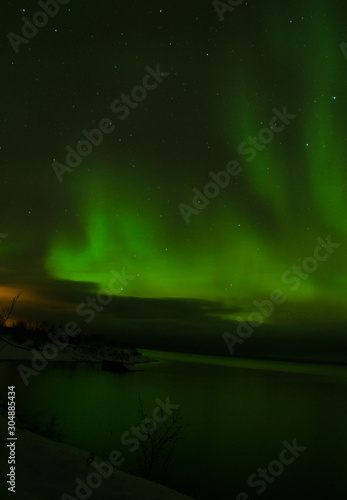 green northern lights aurora borealis in night sky © Jessie