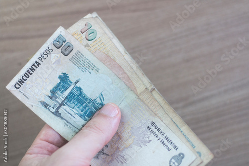 Hand holding Argentinian Money Banknotes - Argentine Money