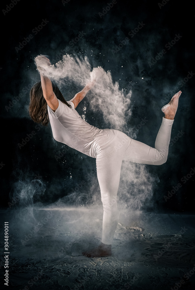 young girl doing yoga poses using powder
