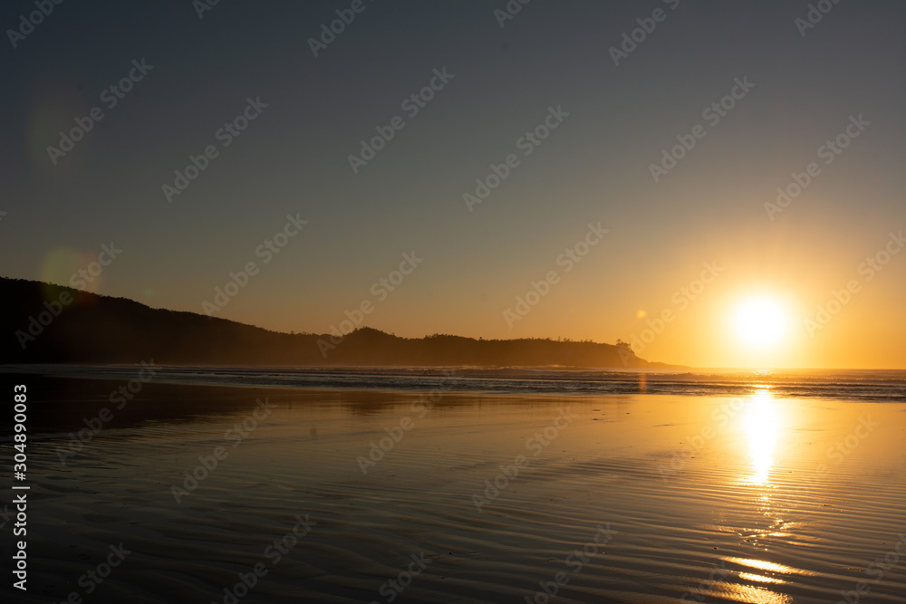 beautiful sandy beach sunset in tofino bc