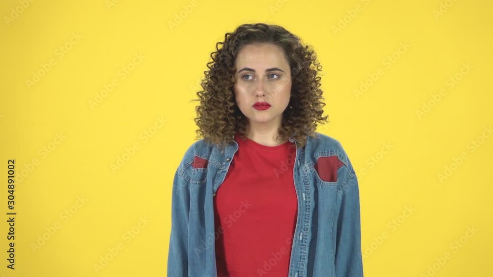 Girl looks confused and shruggs his shoulders, throwing up hands meaning oops sorry feeling guilty confused, slow motion Girl looks confused and shruggs his shoulders, throwing up hands meaning oops sorry feeling guilty confused, slow motion