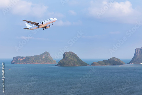  Aerial landscape view white passenger airplane landing above group of small island in tropical turquoise sea travel destinations concept.