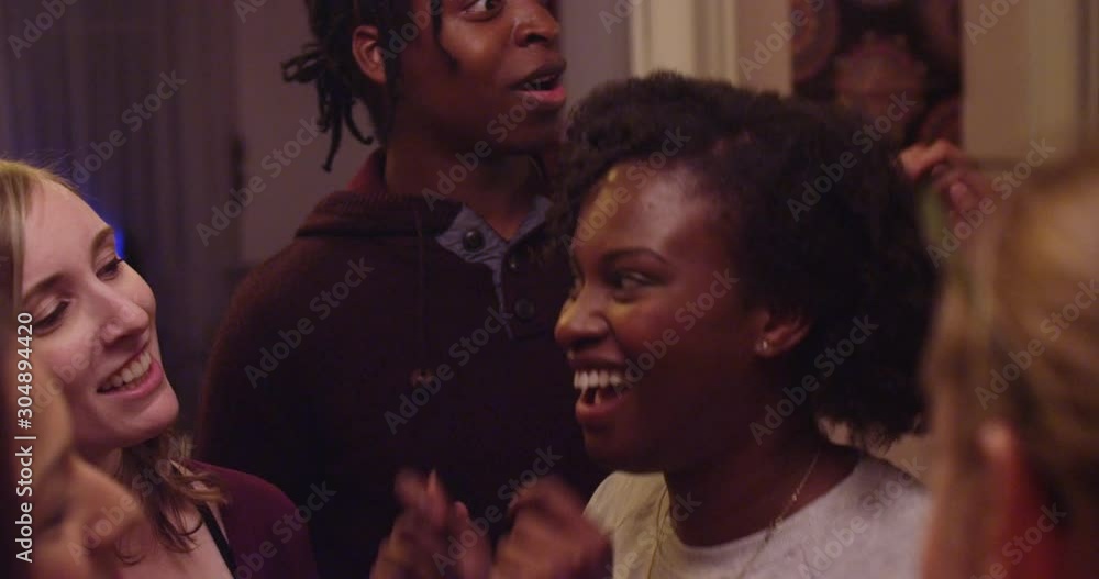 Friends excitedly chattering with each other at a party - shot on RED Friends excitedly chattering with each other at a party - shot on RED