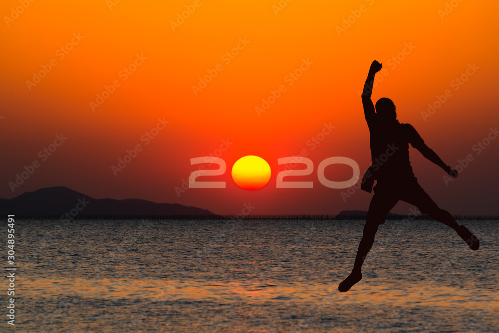 Silhouette man traveler jumping on sunset or sunrise beach with 2020 typography, Tourism travel business planner goal, Time to celebrate New year, Christmas, holidays, Copy space web banner background