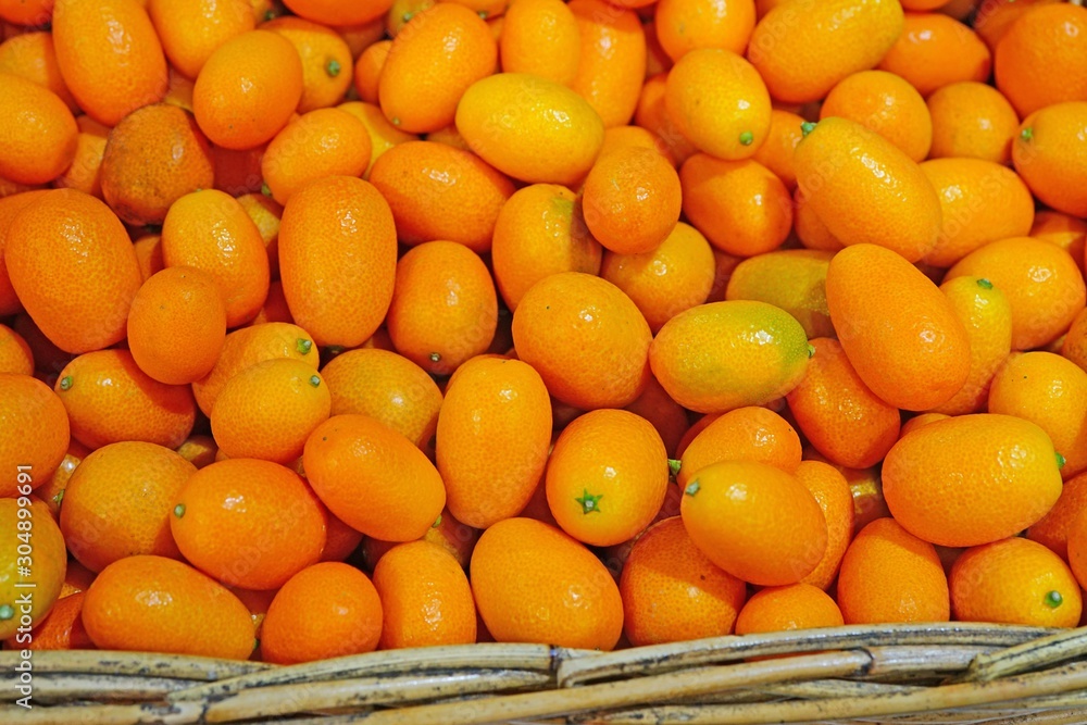 Basket of ripe orange kumquat citrus fruit