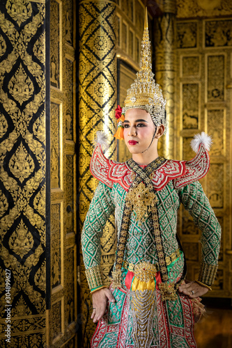 Thai pantomime character In the role of Rama Standing at the house of ancient Thai style, golden beauty