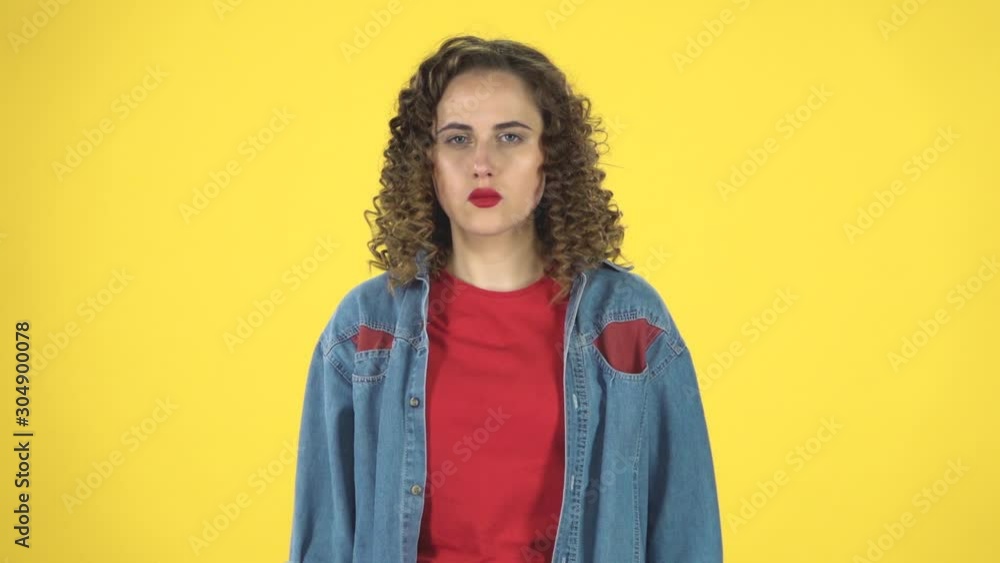Curly woman strictly gesturing with hands crossed making X shape meaning denial saying NO, slow motion Curly woman strictly gesturing with hands crossed making X shape meaning denial saying NO, slow motion