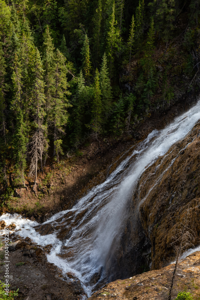 Beautiful View of a waterfall near Grassi Lake during a vibrant summer day. Taken in Canmore, Alberta, Canada. Beautiful View of a waterfall near Grassi Lake during a vibrant summer day. Taken in Canmore, Alberta, Canada.