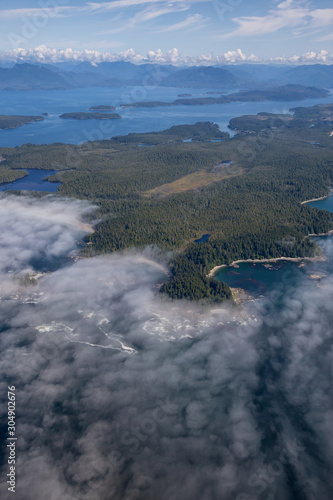 Aerial Landscape View of Beautiful Pacific Ocean Coast with Coastal Mountains at the background during a sunny summer morning. Taken South of Tofino and Ucluelet, Vancouver Island, BC, Canada.