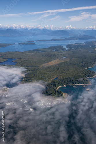 Aerial Landscape View of Beautiful Pacific Ocean Coast with Coastal Mountains at the background during a sunny summer morning. Taken South of Tofino and Ucluelet, Vancouver Island, BC, Canada.